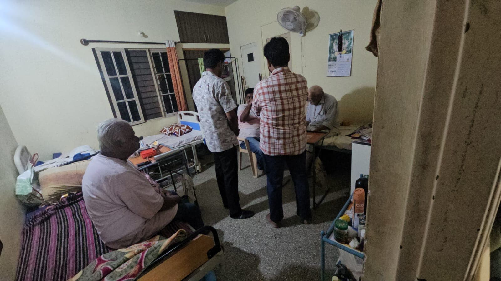 A wider view of the same testing session inside the old-age home